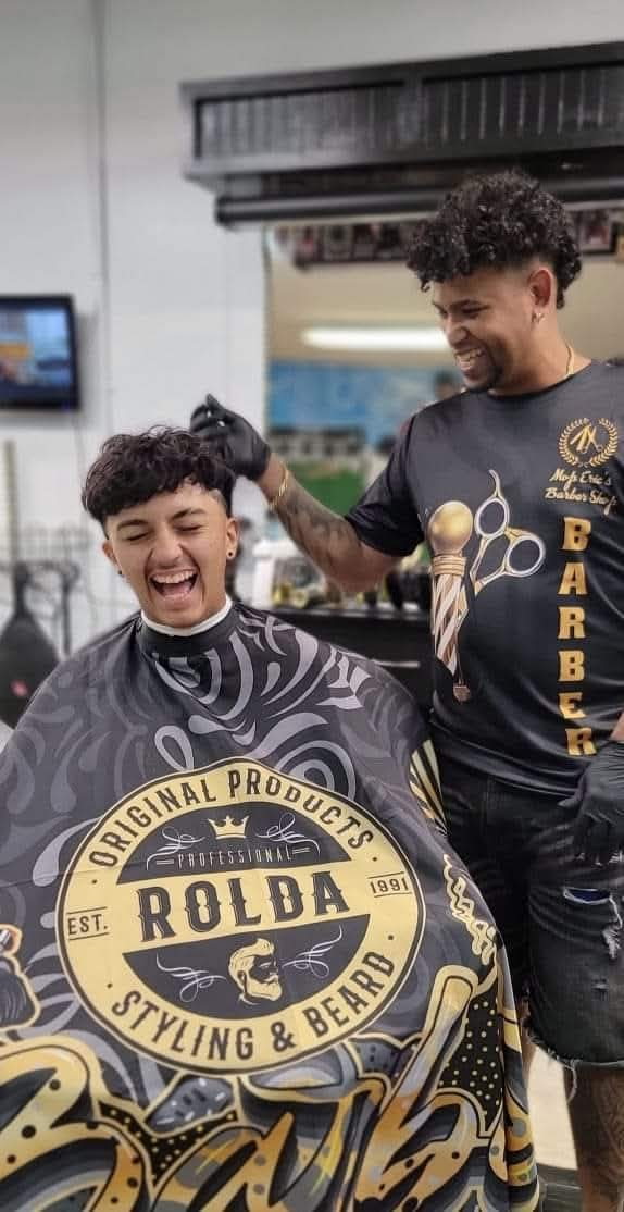 Barber Eric finishing a client's cut at Eric's MVP Barber Shop