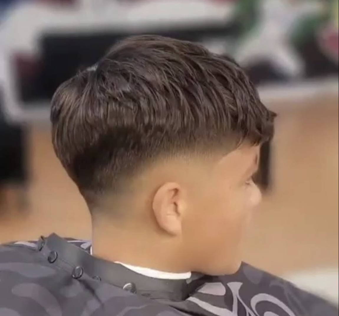Clean textured crop with a low fade, cut at Eric's MVP Barber Shop